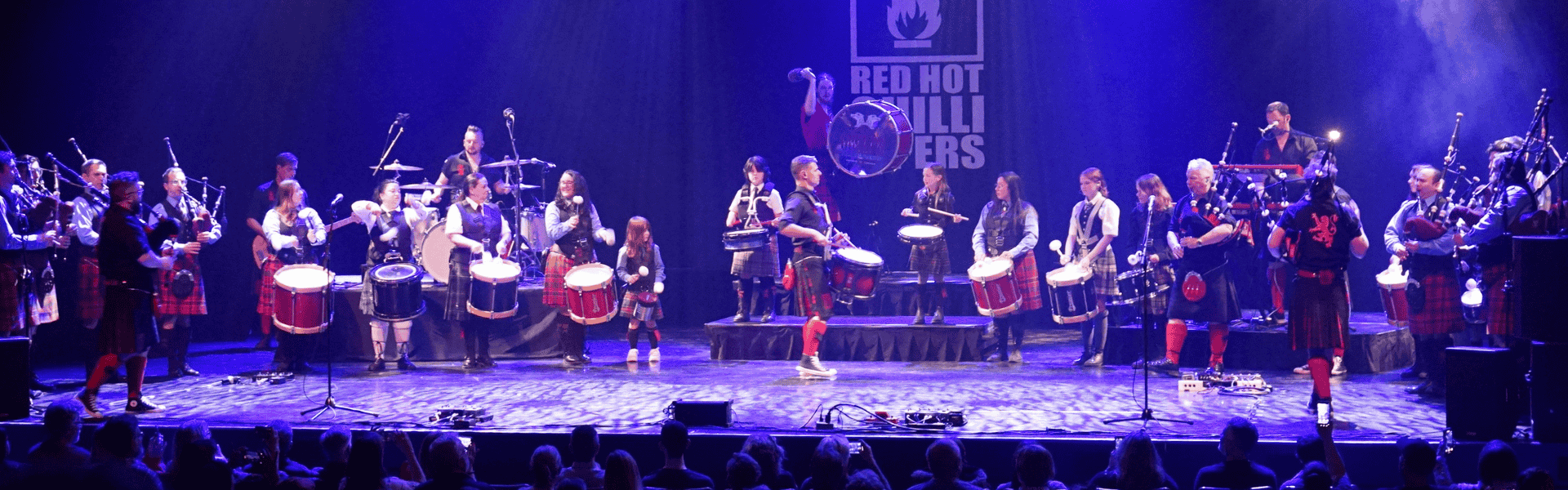 Various Celtic drummers and bag pipers performing on stage